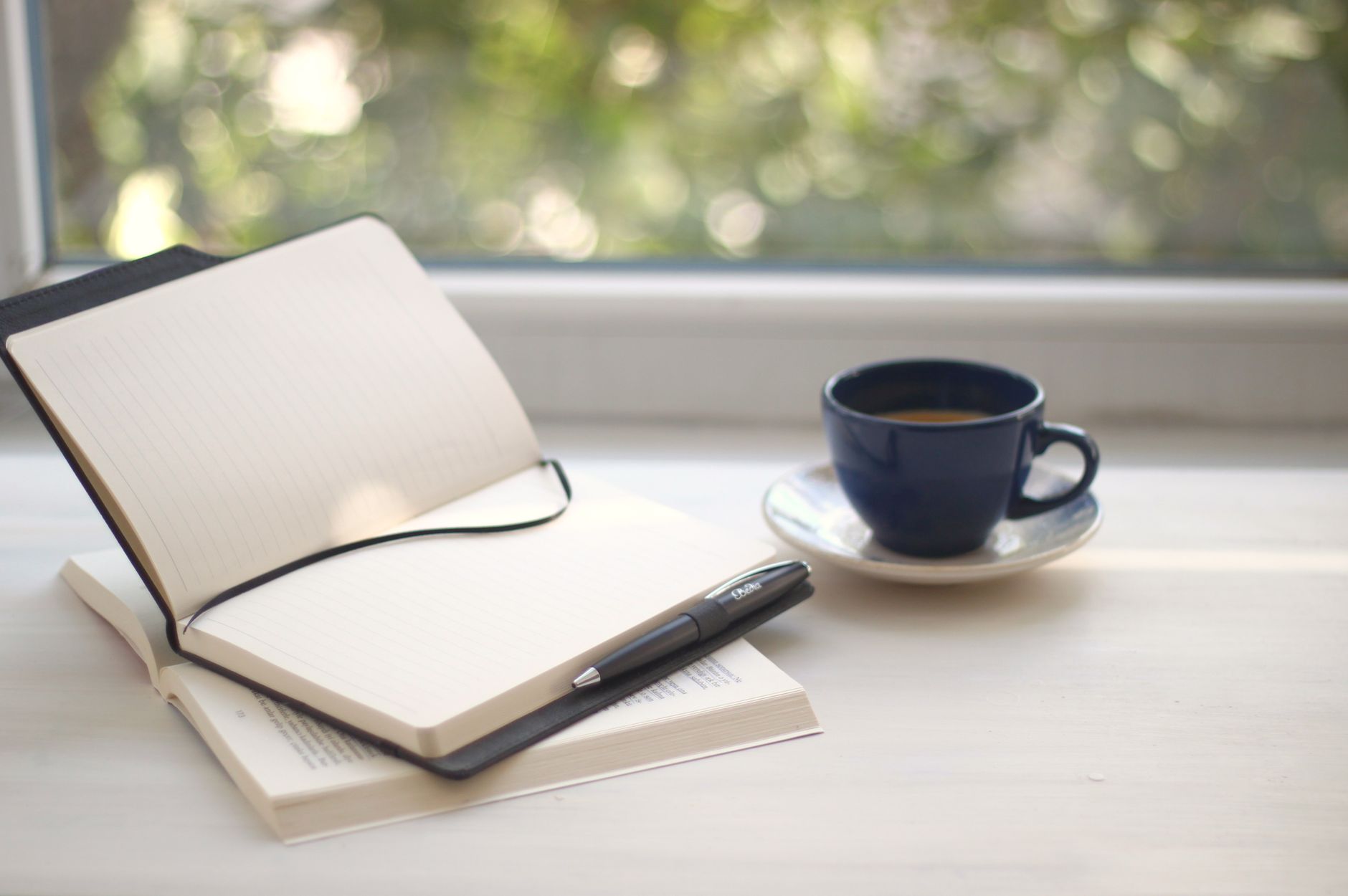 Field notes on wooden table with coffee